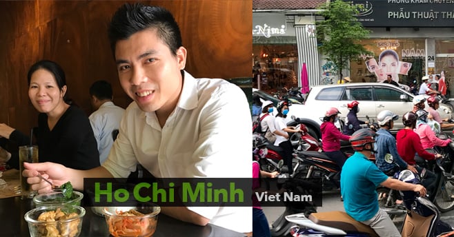 Ho Chi Minh Viet Nam 写真：テーブルについてガラスの器に入った料理を食べている男性と、道路をたくさんのバイクが走っているベトナムの街の様子